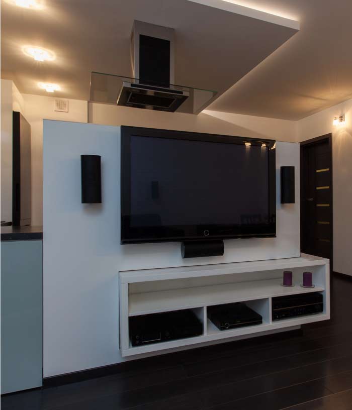 Professional-grade audio visual equipment rack and commercial TV installation with integrated soundbar for business media.