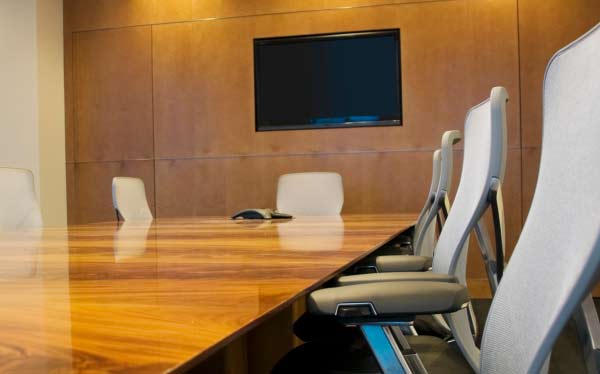 Modern wall-mounted video intercom display unit with digital screen for secure commercial building access and communication.