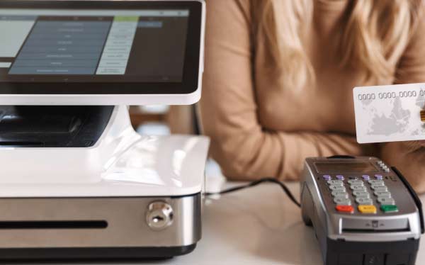 Professional commercial Point of Sale POS system installation with integrated card reader and touchscreen terminal on a clean business counter.